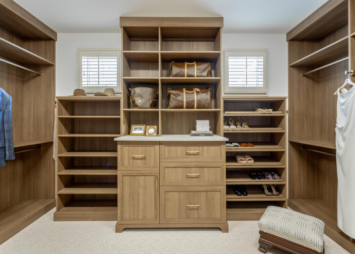 Custom walk-in closet system with shelving and drawers designed by M&R Kitchens in Wallingford CT.
