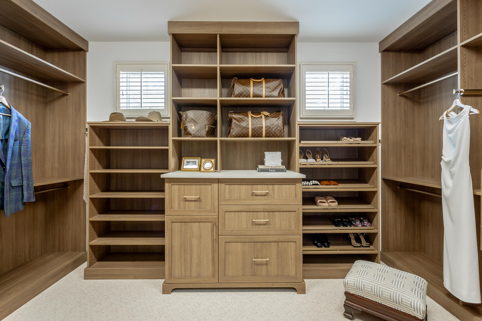 Custom walk-in closet system with shelving and drawers designed by M&R Kitchens in Wallingford CT.