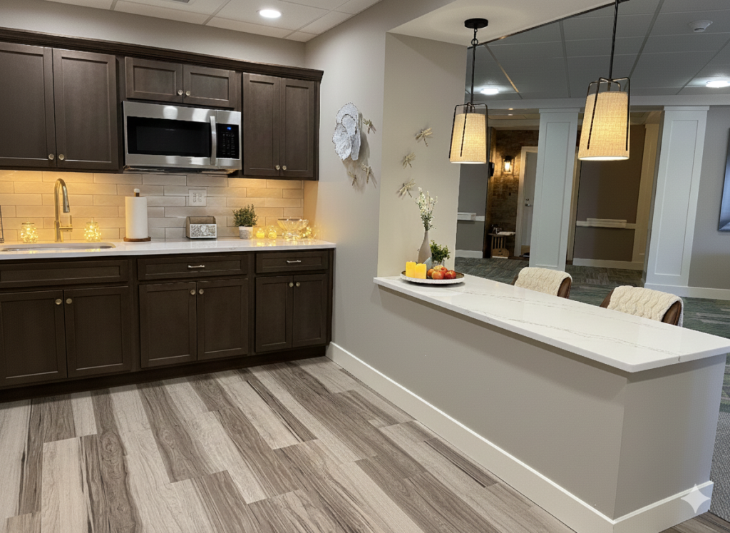 Communal kitchen and bar area featuring dark brown shaker-style cabinets, white subway tile backsplash, white quartz countertops, and decorative pendant lighting over a service peninsula.